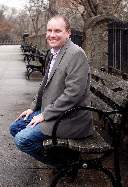 Dustin Rubenstein sitting on a park bench in Morningside Park.