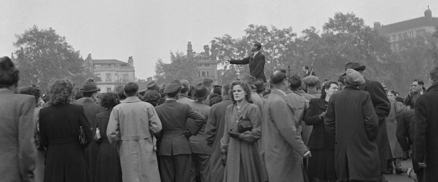 Crowd gathered listening to a speaker at Speakers Corner in Hyde Park, London.